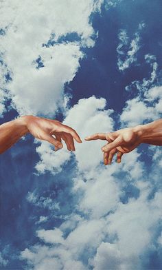 two hands reaching out towards each other in front of blue sky with white fluffy clouds