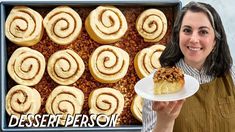 there is a woman holding a plate with desserts on it and in front of the pan