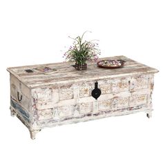 an old chest with flowers on it and a potted plant in the top drawer