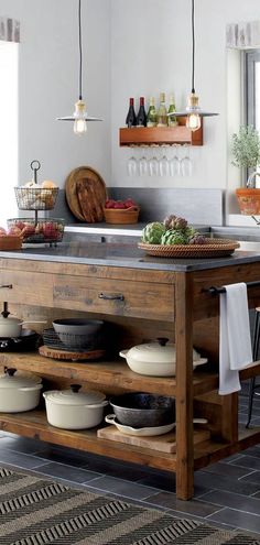 a kitchen island with pots and pans on it