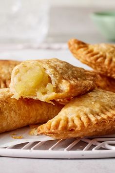 three pastries on a plate with a bite taken out