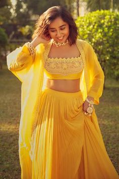 a woman in a yellow outfit posing for the camera