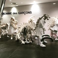 statues of people dressed in native american gargoons are lined up against a wall