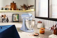 a blue mixer sitting on top of a kitchen counter