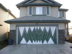 a garage with a green and white design painted on the side of it's door