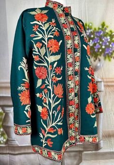 Experience the timeless elegance of our Traditional Kashmiri Floral Ari Embroidery Short Designer Jacket. Crafted with meticulous attention to detail, this versatile woolen coat features exquisite floral embroidery, reflecting the rich heritage of Kashmiri craftsmanship. With its button-up style and fully lined interior, it offers both sophistication and comfort. Elevate your winter wardrobe with this fine quality piece, blending traditional artistry with modern versatility effortlessly Conditio Designer Jacket, Coat Style, Work Shorts, Woolen Coat, Easy Sewing Projects, Indian Cotton, Jacket Design, Coat Fashion, Up Styles