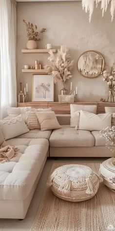 a living room filled with white furniture and lots of pillows on top of the couch