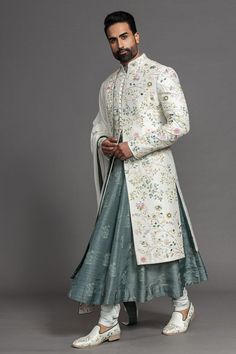 a man in a white and green sherwa