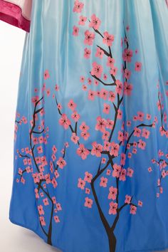 a blue dress with pink flowers painted on it