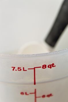 a measuring cup with a spoon in it