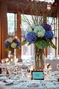 there is a vase with flowers in it on top of the table at this wedding reception