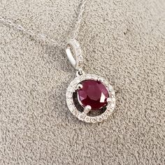 "Ruby & Diamond Halo Pendant!! 14k White Gold pendant is featuring a 6.83mm Round Genuine Red Ruby (1.67ct), with a sparkling Halo of .28ct in Genuine Diamonds surrounding this BEAUTIFUL BRIGHT RED RUBY! Clean, Classic, and strong, this timeless beauty will never go out of style. The chain in the photos is included. It is a 14k white Gold loose pendant rope style chain, and 18\" in length. **Ruby is the official July Birthstone** **Diamond is the official April Birthstone** **Please feel fre July Birthstone Jewelry, Ruby Pendant, April Birthstone, Halo Pendant, Jade Ring, Star Ruby, Jade Jewelry, July Birthstone, Ruby Diamond