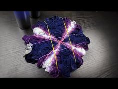 a purple and white umbrella sitting on top of a wooden table