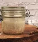 a glass jar sitting on top of a wooden table