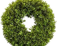 a round boxwood wreath on a white background