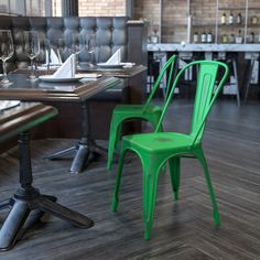 two blue chairs sitting next to each other on top of a hard wood floor in a restaurant