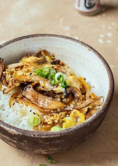 a close up of a bowl of food with rice and vegetables in it on a table