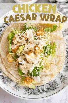 chicken caesar wrap on a plate with lettuce and cheese