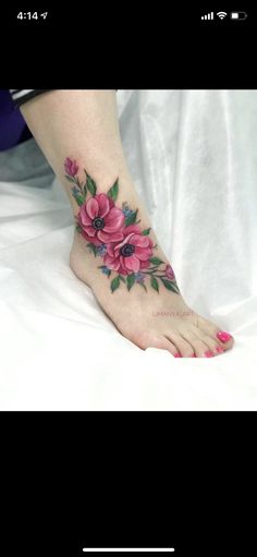 a woman's foot with pink flowers on it