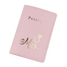 a pink passport case with gold lettering and a crown on the front, sitting on a white surface