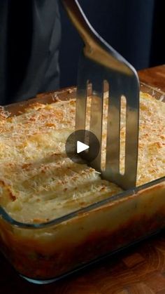 a spatula scooping cheese into a casserole dish