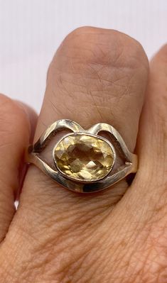 This is a lovely citrine statement ring in 925 sterling silver Size 7.5  Our jeweler can re size this for a $20 fee.  Citrine, a birthstone of November, is often the gemstone associated with the thirteenth wedding anniversary.  A citrine is a yellow to orange variety of quartz, which is a crystallized form of silica.  The yellow color results from iron trapped in the silicon matrix. The citrine draws its name from the Latin word citrina.  Citrine brings a activating energy balancing and stimulating and balancing the Solar Plexus chakra.  The Citrine signifies energy, vitality and prosperity. Citrine is a relatively hard stone rating 7 on Moh's scale. Citrine can be cleaned with mild soap in warm water, and a soft toothbrush or cloth.  Avoid harsh cleansers, bleach, chemicals other chemical 13th Anniversary, Energy Balancing, Latin Word, Vintage Cocktail Ring, Yellow Gemstones, Solar Plexus Chakra, Citrine Ring, November Birthstone, Ring Vintage