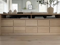 a living room with a large wooden dresser