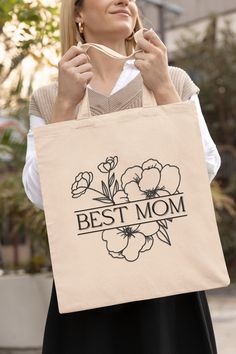 "About: \" BEST MOM; Mother's Day tote bag, floral Birthday tote bag perfect a Birthday gift. This 100% cotton bag comes in one size - 15\" x 16\"- perfect for everyday wear. . The bag features 20\" handles (made from the same canvas), making it easy to carry even with a week's worth of shopping. .: 100% cotton canvas. .: Available in natural color. .: Heavy fabric. .: Sewn-in label." Mother's Day Tote Bag, Mothers Day Tote Bag, Mom Flowers, Mother Painting, For Mom, Flowers Tote Bag, Mom Bag, Mom Tote Bag, Flowers Tote