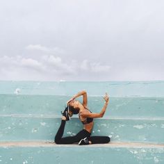 a woman is doing yoga on some steps