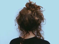 the back of a woman's head with curly hair