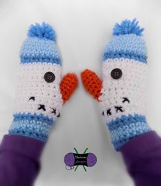 two crocheted snowmen with blue and white gloves