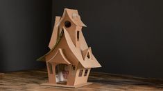 a bird house made out of cardboard sitting on a table