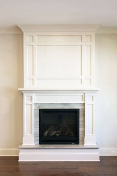 an empty fireplace with white paint on the mantle