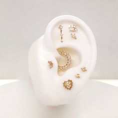 an ear with several different types of earrings on it