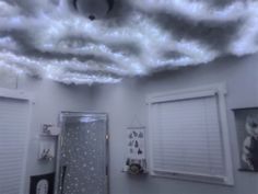 a bathroom with clouds in the ceiling and pictures on the wall