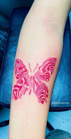 a red butterfly tattoo on the left arm and right arm, it looks like an intricate design