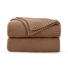 the brown blanket is folded on top of each other, and it's made out of