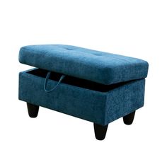 a blue ottoman sitting on top of a wooden table