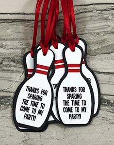 two bowling pins hanging from a red ribbon with thank for sparkling the time to come to my party