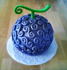 a blue cake with swirly icing on top