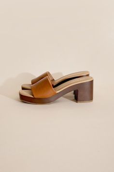 Step into style and comfort with the Lauren Slide Sandal. Crafted with vegan leather, these slide mules feature a lightweight wooden heel for a chic and effortless look. Perfect for any occasion, these sandals are sure to elevate your outfit with their unique and playful design. Fit true to size. Unique Heels, Platform Design, Mule Heels, Platform Mules, Platform Block Heels, Footwear Collection, Leather Slides, Handbag Shoes, Easy Workouts