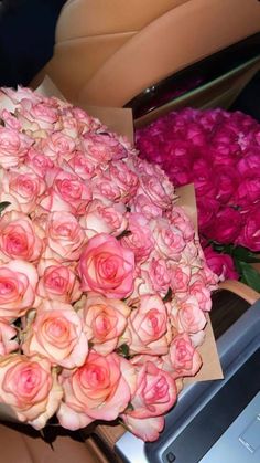 a bouquet of pink roses in a car