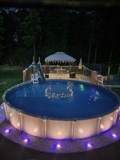 an above ground pool with lights around it