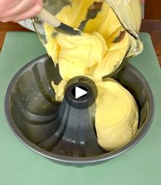 a person mixing batter in a metal bowl