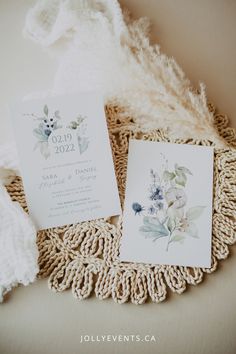 the wedding stationery is laid out on a doily