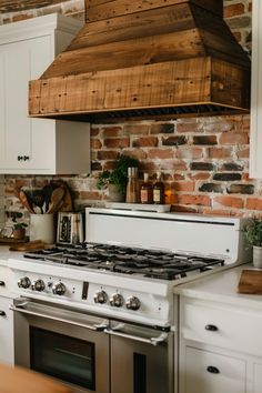 a stove top oven sitting inside of a kitchen next to a counter and cupboards