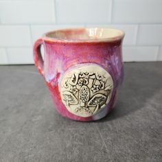 a red and white cup sitting on top of a counter