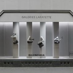 an assortment of shoes on display in front of a white wall with the word galaeries lafayette