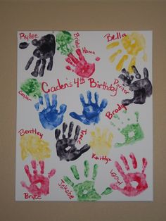 handprints are displayed on a white paper with words written in different colors and sizes