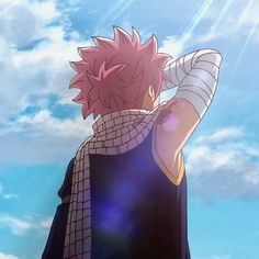 an anime character with pink hair standing in front of blue sky and clouds, holding his hands to his head